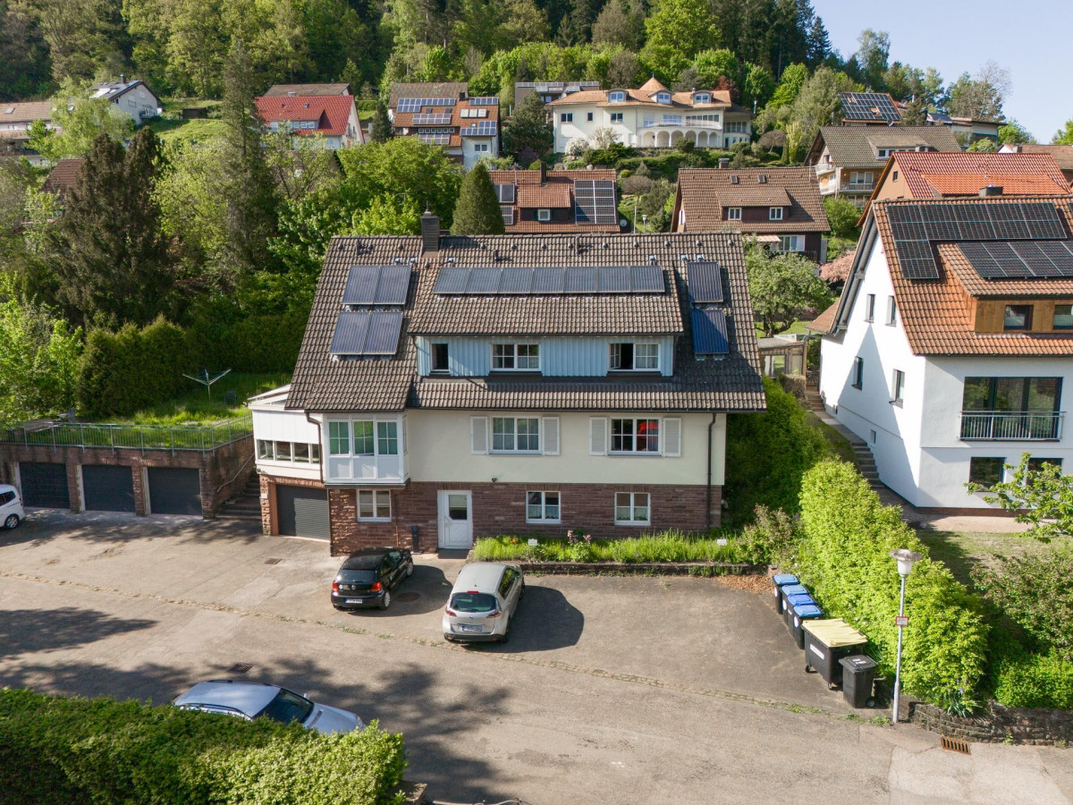 Luftaufnahme zweier Wohnh&auml;user mit G&auml;rten und Parkpl&auml;tzen.