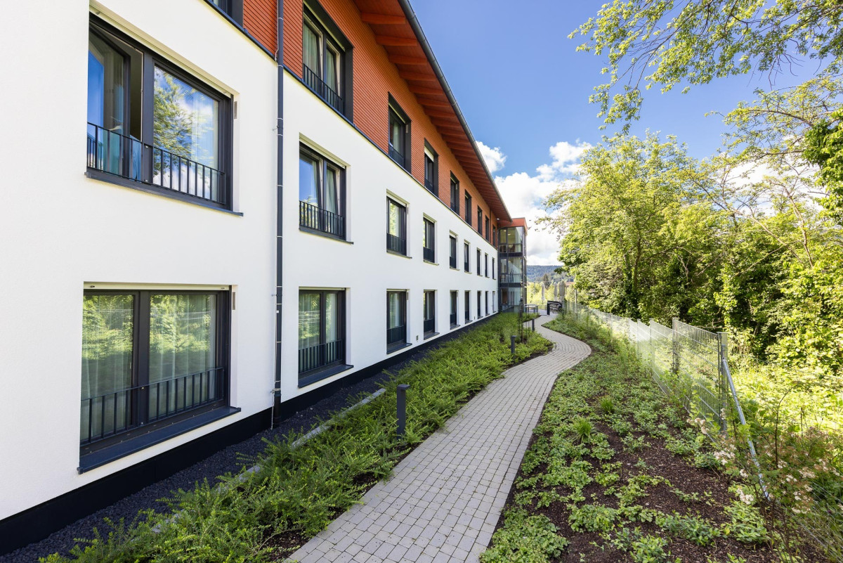 Modernes Seniorenzentrum mit heller Fassade und gepflegtem Au&szlig;enbereich.